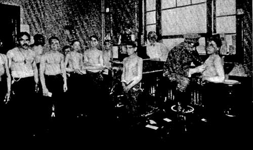 EXAMINING IMMIGRANTS AT ELLIS ISLAND, NEW YORK