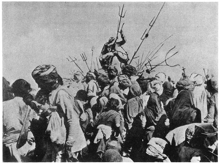 Devotees, possessed, embracing each other, while supported on tridents, at Siva’s fair at Pachmarhi