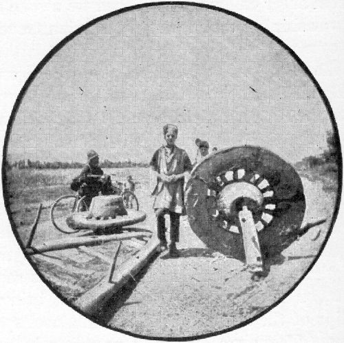 A PERSIAN REPAIRING THE WHEELS OF HIS WAGON.