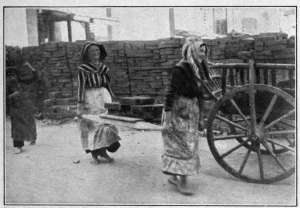 Photograph from Henry Ruschin WOMEN CARRYING BRICKS AT BUDAPEST A pathetic aspect of the policy "Business as Usual" inaugurated at the outbreak of the European War. Central European women worked hard before the war, however.