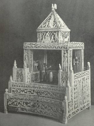 Elaborately Carved Ornamental Design in Bone Work, Representing a Theatre, with Figures in Carved Bone on the Stage, the Work of the Norman Cross Prisoners of War.  Height 14 inches, base 9 inches square.  Peterborough Museum