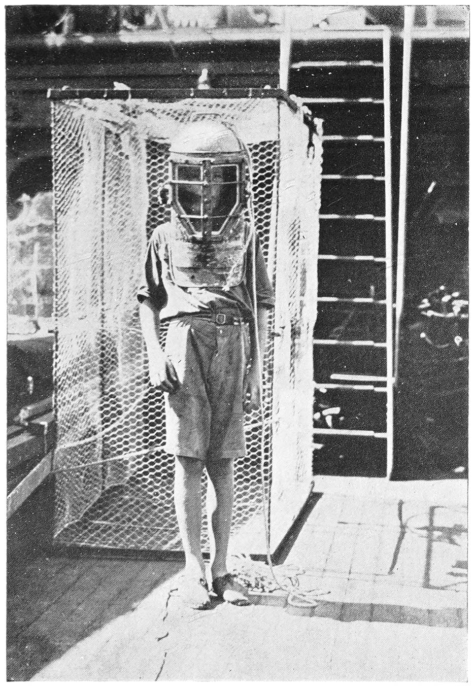 In the Diving Helmet, Standing in Front of Shark Cage.