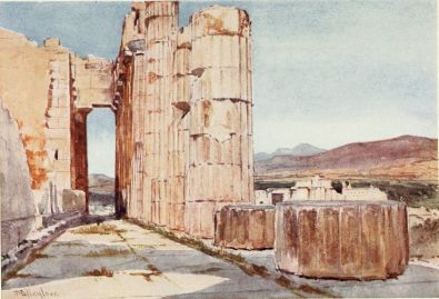 VISTA OF THE NORTHERN PERISTYLE OF THE PARTHENON, LOOKING
WESTWARD

Out of the seventeen columns of the northern peristyle the remains of
fourteen, more or less perfect, may be counted on the right. Six of
them, which have stood unmoved for more than twenty-two centuries, are
distinguished by their splendid colour, almost matching in this respect
the second column of the west front, which is also visible. The remains
of the north cella wall are seen to the left. The two drums of columns
in shadow in the foreground reflect the pure blue of the early morning
sky. Over their tops may be seen part of the Propylæa, and the mountains
of Daphni and Megara.