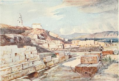 THE GREAT TEMPLE OF THE MYSTERIES, ELEUSIS. LOOKING
NORTH-EAST

On the left, in the immediate foreground, is part of the early girdle
wall of the sacred precincts, above which is the edge of the Acropolis
rock, with a chapel of the Panagia, and belfry above. To the right are
bases of votive offerings. In the distance are the mountains of
Attica.