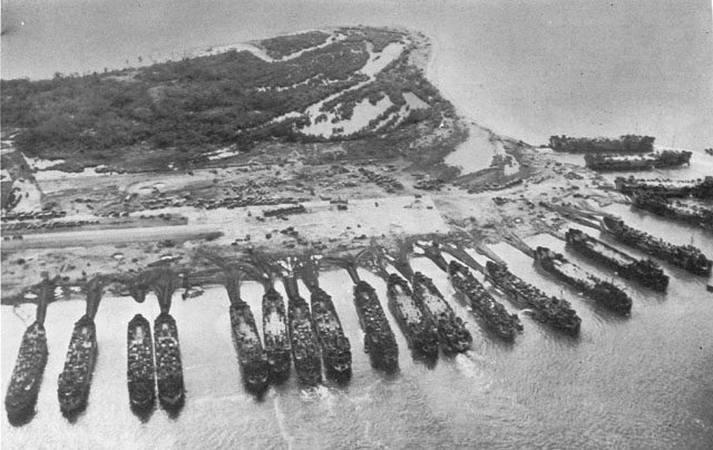 LST&rsquo;S UNLOADING AT TACLOBAN AIRFIELD. The causeways leading from the beach to the ships were built by bulldozers scraping sand and earth to each ship as it landed.